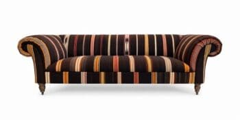 Anatolia Kilim Sofa bekleed met echte Turkse tapijten in warme bruin-, rood-, oranje- en beigetinten; ieder exemplaar is uniek.